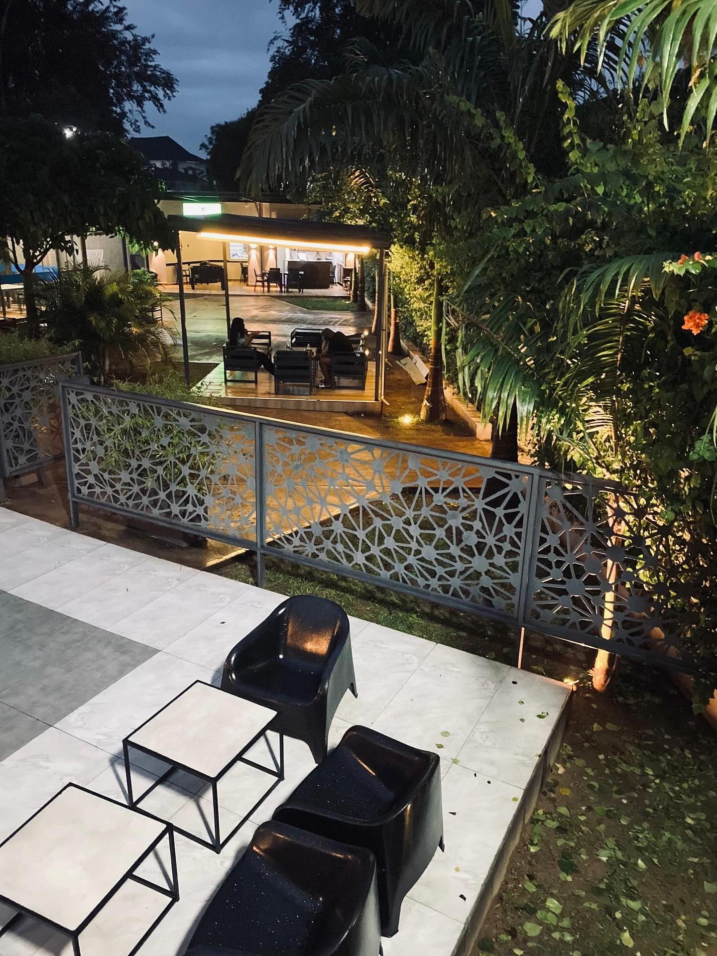 Outdoor terrace and seating at Seven Lugard after dark.