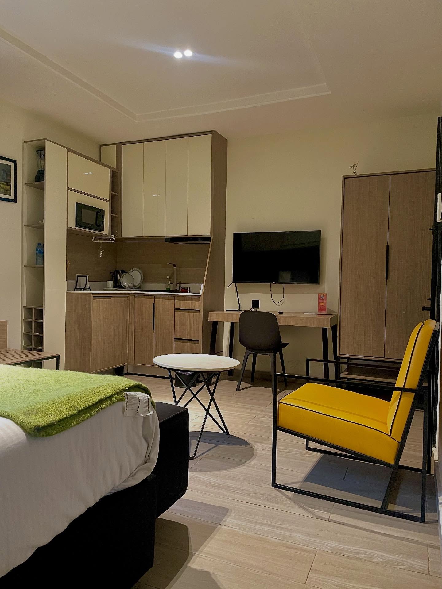 Seven Lugard apartment with a desk, television, and seating